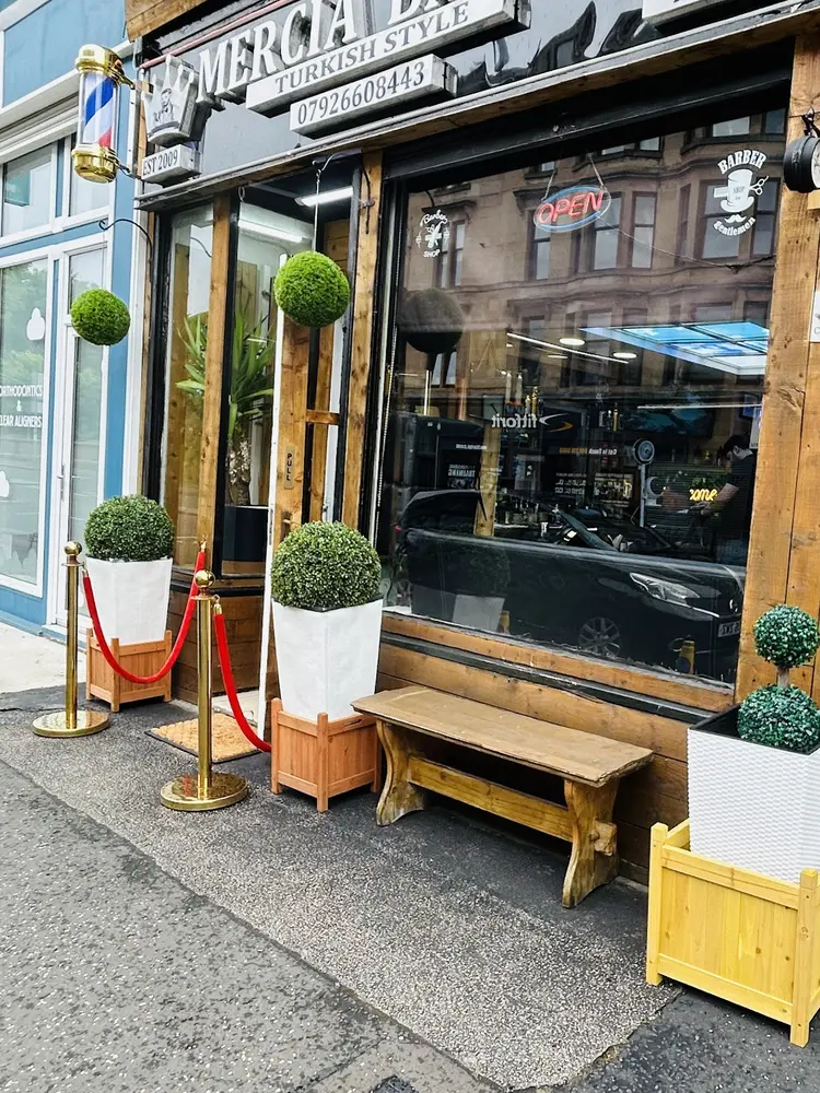 Mercia Barbers frontage with barber pole and red velvet rope